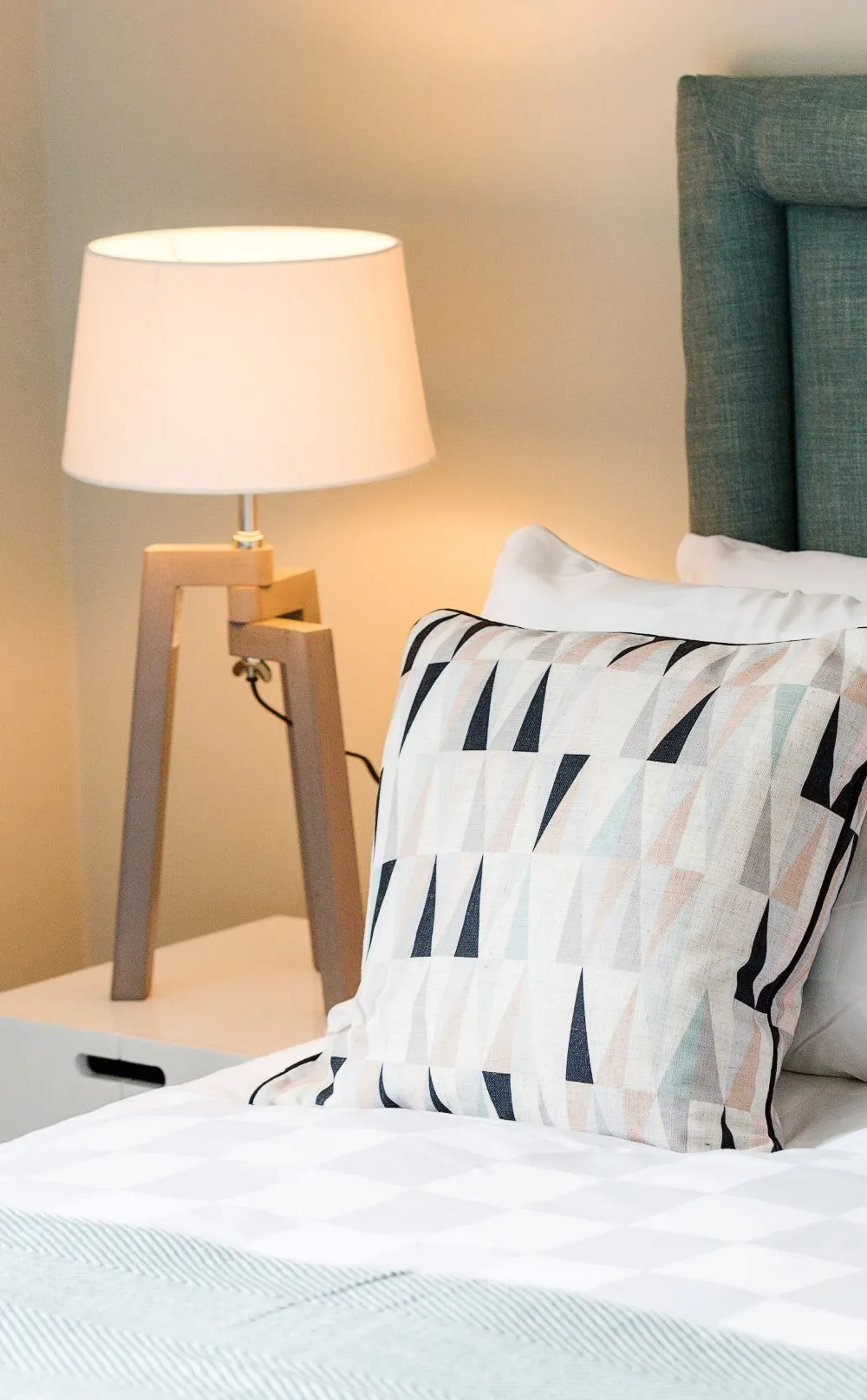 lit lamp beside table