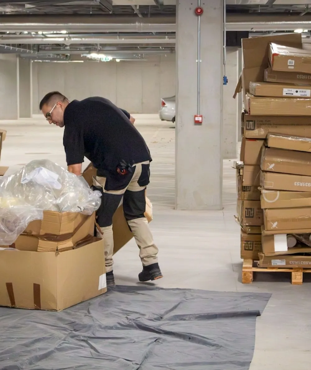 logistics personnel unwrapping boxes
